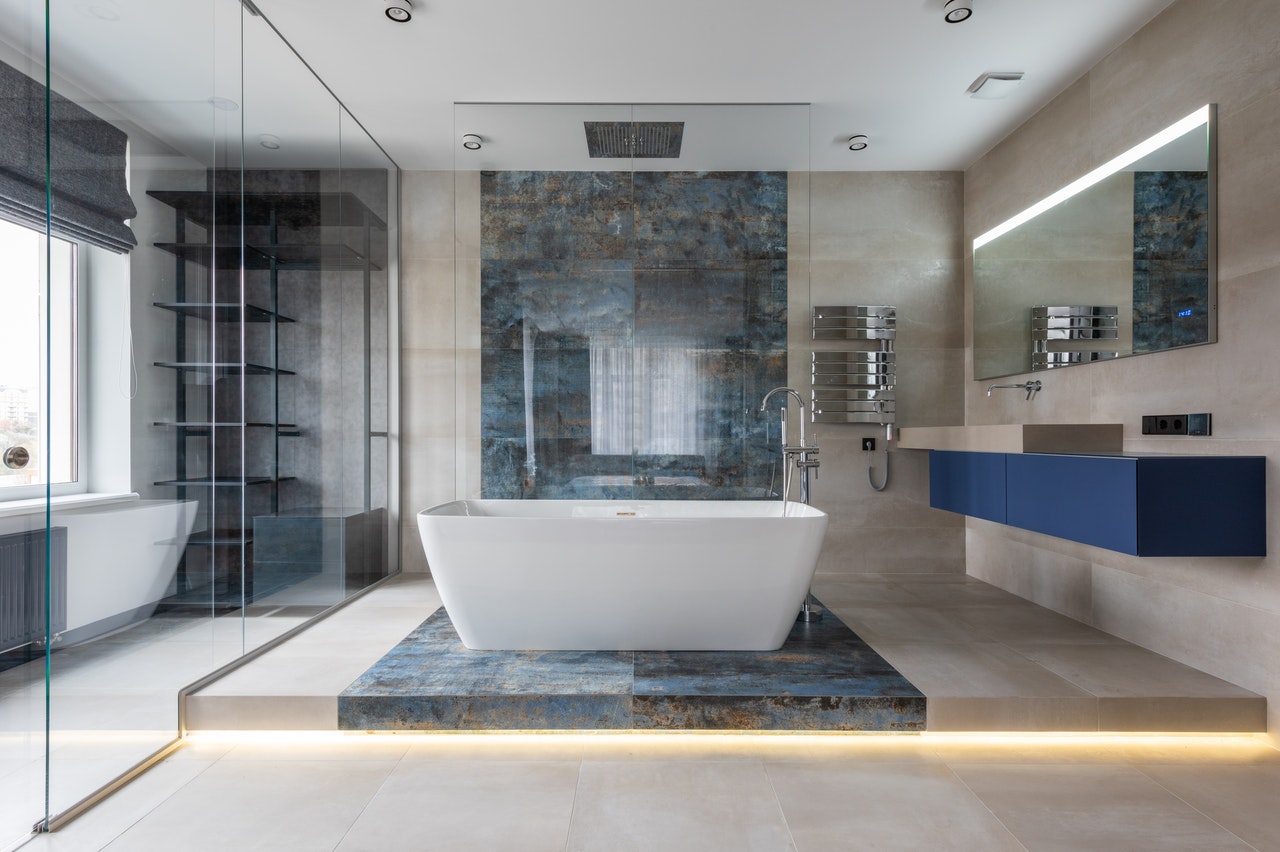 Navy blue bathroom with bathtub as a focal point